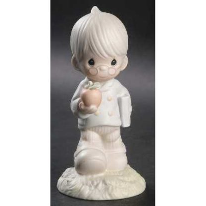 porcelain figurine depicts a Boy In Glasses With Book and Apple.