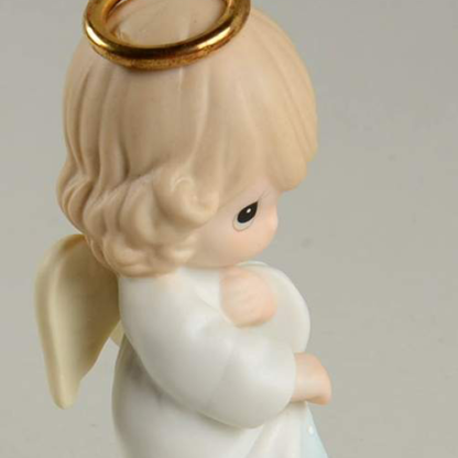porcelain figurine depicts an angel with a gold halo and birthstone (sapphire rhinestone)