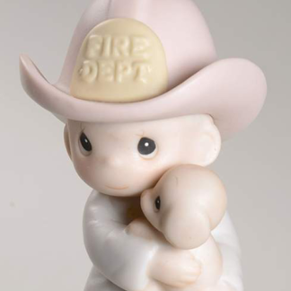 porcelain ornament of a Fireman holding a puppy.