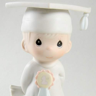 porcelain figurine depicts a boy graduate.