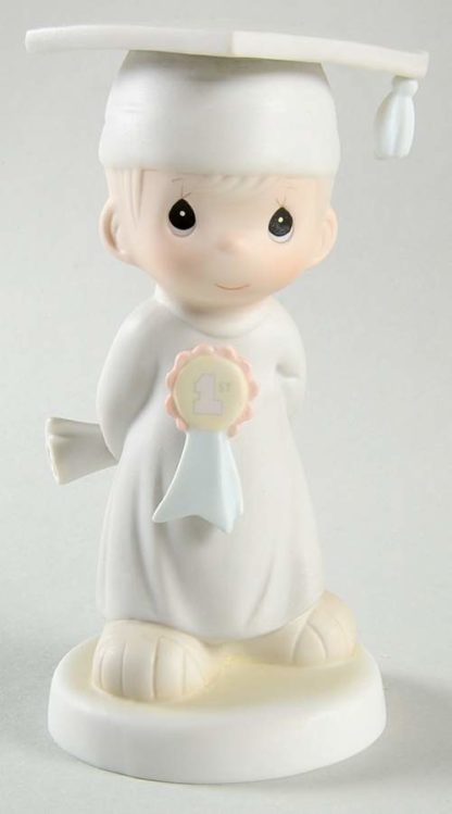 Precious Moments God Bless You Graduate #106194. Precious Moments porcelain figurine depicts a boy graduate.