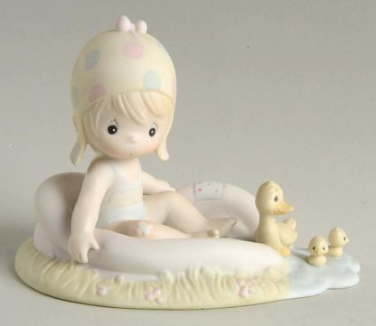 Precious Moments figurine of August part of the Calendar Girl series. Depicts a girl in a pool with ducks.