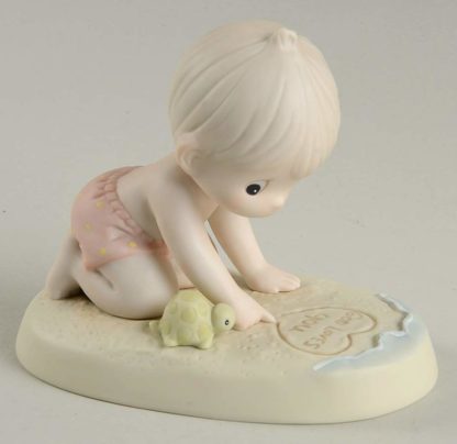 Precious Moments porcelain figurine called Love Letters in the Sand features child playing in sand with turtle
