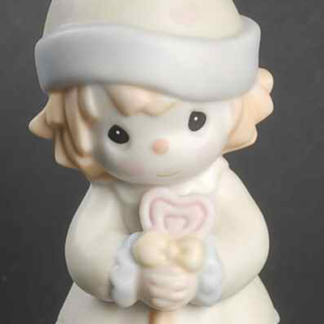 Porcelain figurine of girl clown holding a lollipop