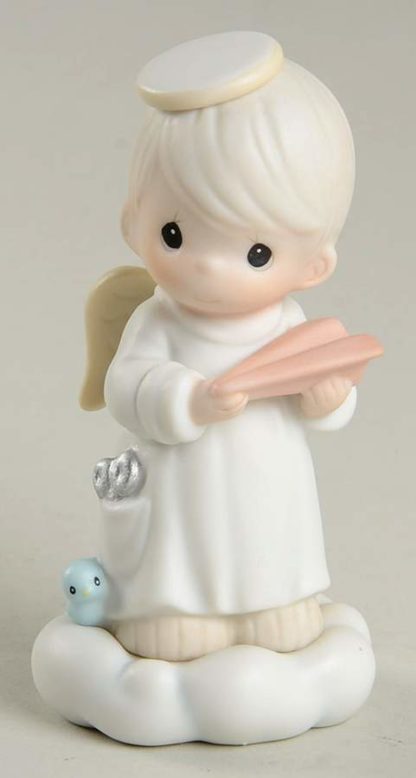 This porcelain figurine depicts a boy angel with a paper airplane.