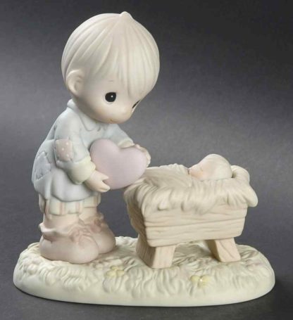 Precious Moments figurine of a shepherd boy giving a heart to Baby Jesus.