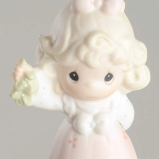 Porcelain ornament of girl holding mistletoe