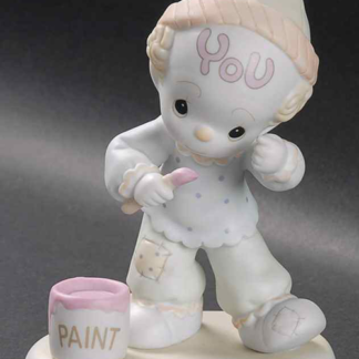 Precious Moments figurine depicts a clown painting his forehead.