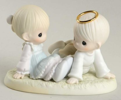 Precious Moments porcelain figurine of Heaven Must Have Sent You depicting little girl with angel
