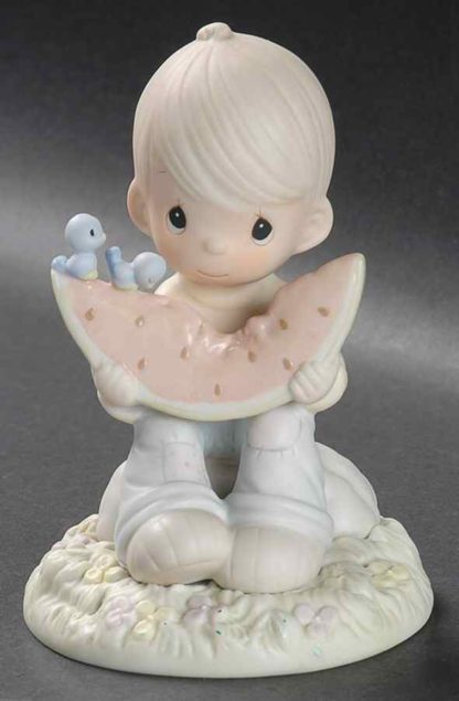 Precious Moments figurine depicts a A Boy And Bluebirds Eating A Slice Of Watermelon.