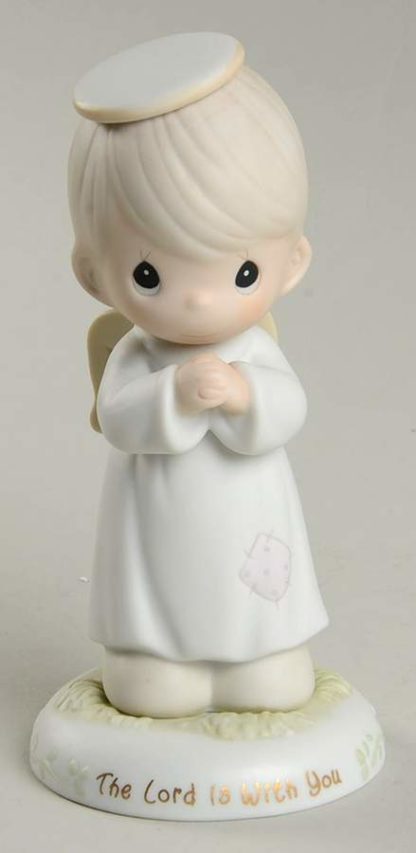 Precious Moments figurine depicts a angel, praying.