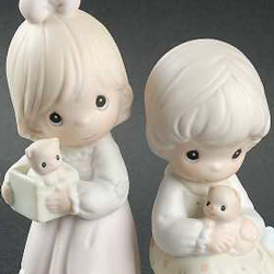 porcelain figurine featuring two girls with kittens.