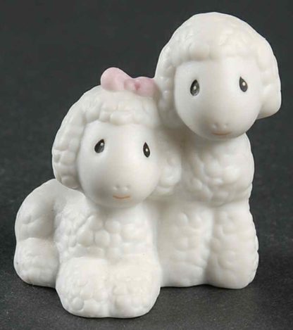 Porcelain figurine depicting boy and girl sheep.
