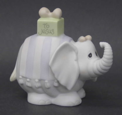 Precious Moments Happy Birthday Jesus #530492.  Precious Moments porcelain figurine features an elephant with a gift on its back.