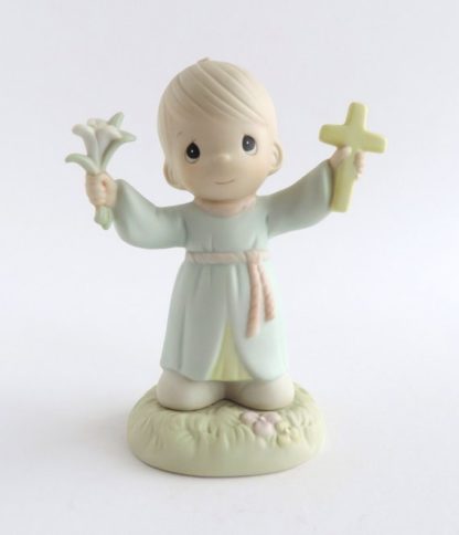Porcelain figurine boy holding lily and cross