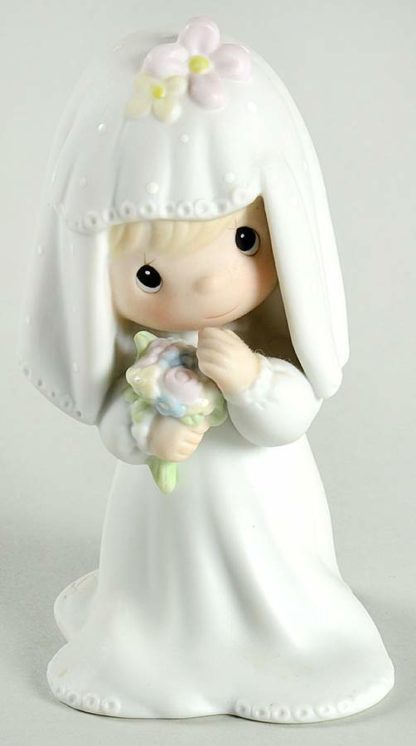 Precious Moments Bride (Bridal Series) #E2846. Porcelain figurine depicts a bride blushing bride.
