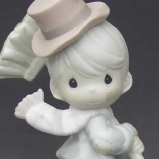 Porcelain Precious Moments figurine depicts a boy chimney sweep in hat and scarf with broom.