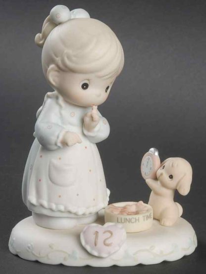 Porcelain figurine from the Growing In Grace series, this piece depicts a girl with a puppy holding a clock