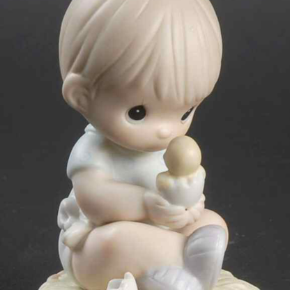 Porcelain figure of baby boy holding with baby duck.