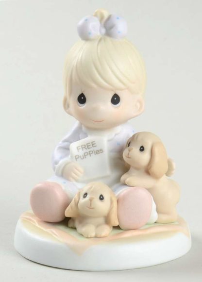 Figurine of baby girl with puppies.