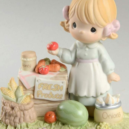 Porcelain Precious Moments figurine depicts a girl at a Fresh Produce stand with vegetables and fruit.