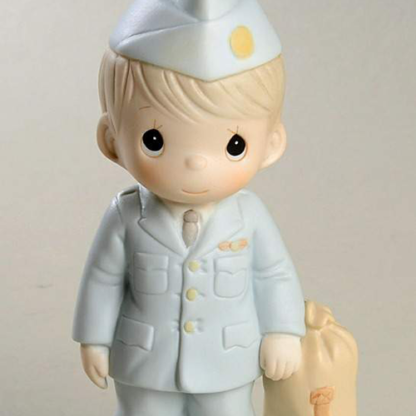 Porcelain Precious Moments figurine depicts an Airman standing beside a duffel bag.