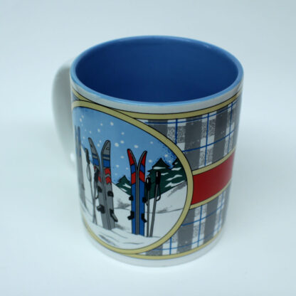 Novelty Mug, three pairs of skis in Snow scene, Grey plaid with red band round middle