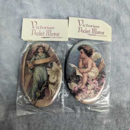 Victorian Pocket Mirrors. - Angel with banner and lily - Cherub on roses with list